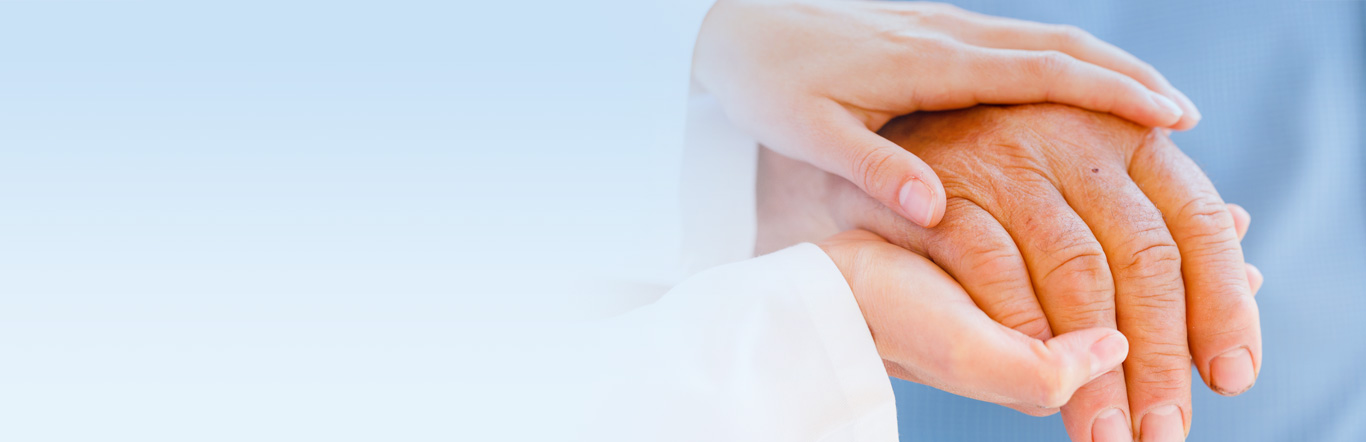 Doctor holding elderly persons hand.
