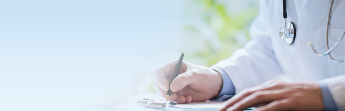 Doctor writing on a desk.