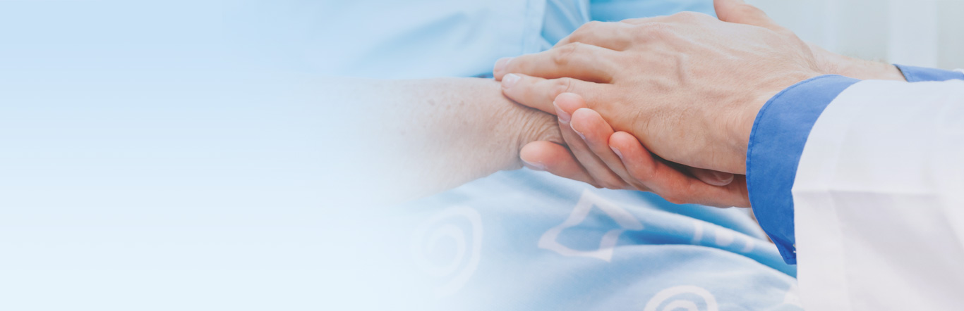 Doctor holding elderly persons hand.